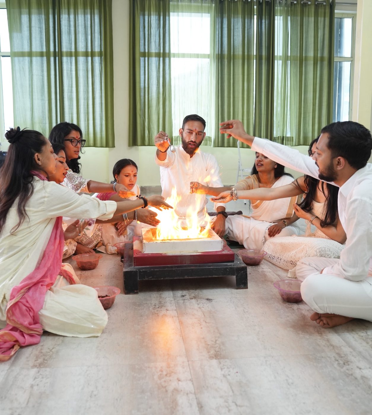 Students seated around a sacred fire ceremony